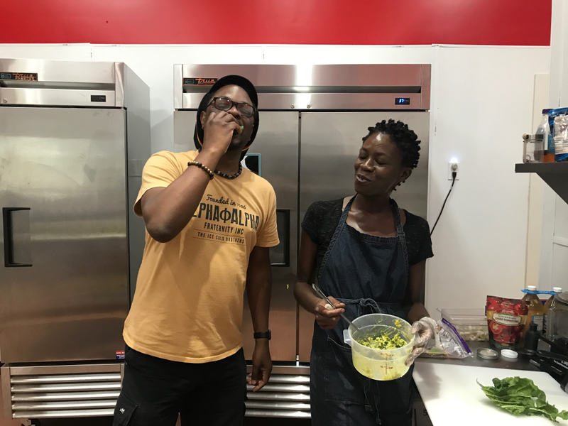 Lawrence Ross samples the wares of Recipe owner Tisha Crear. (Lawrence Ross/The Root)